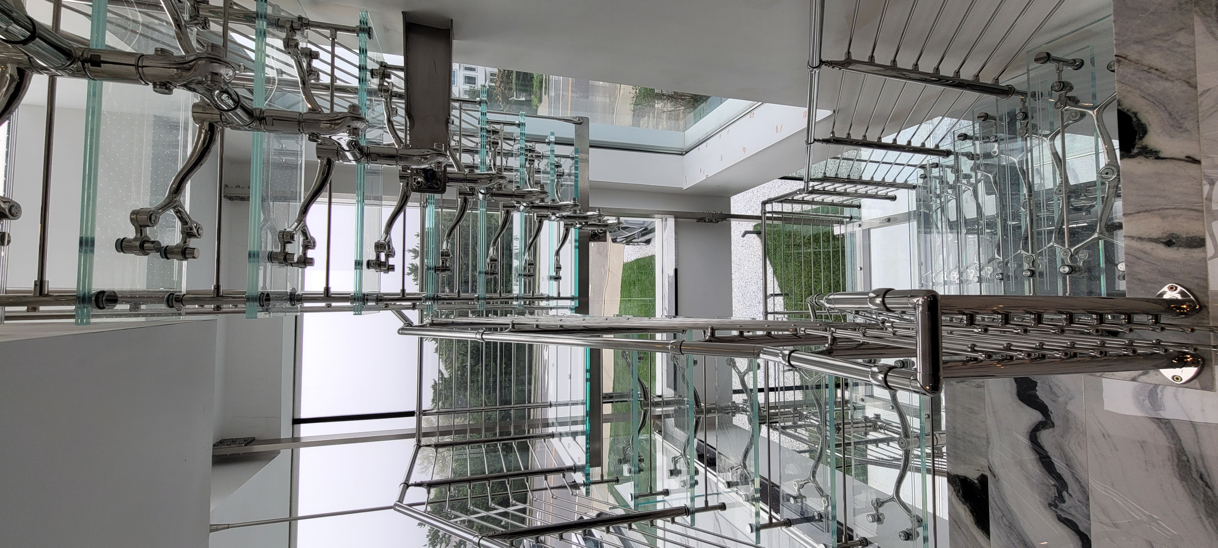 All-glass custom staircase in a Long Island atrium